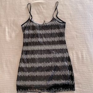 Mini dress w/ silver/black sequins. Slightly stretchy & has 1/3 in straps.